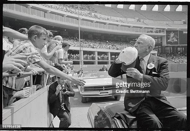 Young baseball fans reach out to shake the hand of Casey Stengel here, as he passes in car at Busch Memorial Stadium where 26 living members of the...