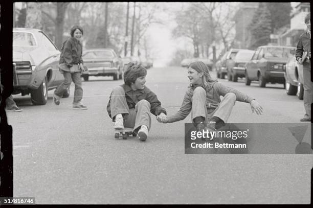 Hand-in-hand a couple skates, Michael Anastasic and Patricia Kiecka sail down a Brooklyn street on their skateboards as milder temperatures begin to...