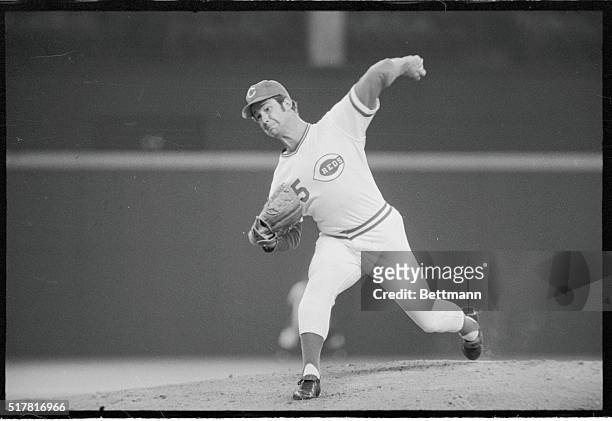 Reds' southpaw Don Gullett grimaces as he fires one at the Red Sox and then tips his cap to cheering fans as he's relieved with two outs in the ninth...
