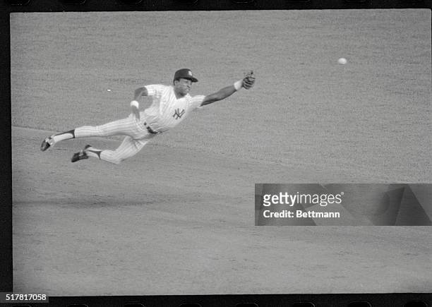 New York: Yankee second baseman Willie Randolph dives in valiant attempt to snare the Red Sox' Butch Hobson's drive in the 17th inning of continued...