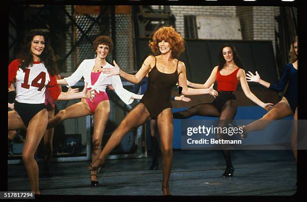 Surrounded by Rockettes in New York City's famed Radio City Music Hall, Ann-Margret rehearses 9/15 for a television tribute to the high-kicking...