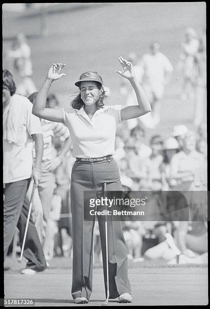 Mason, Ohio: Rookie Nancy Lopez holds up her hands in victory after parring the 18th hole to win the LPGA Championship by six strokes over Amy Alcott...