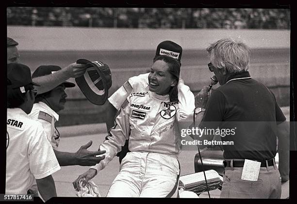 Indianapolis Speedway: Hands reach out for Janet Guthrie in qualifying circle 5/20 after she finished the required run on the speedway to qualify for...