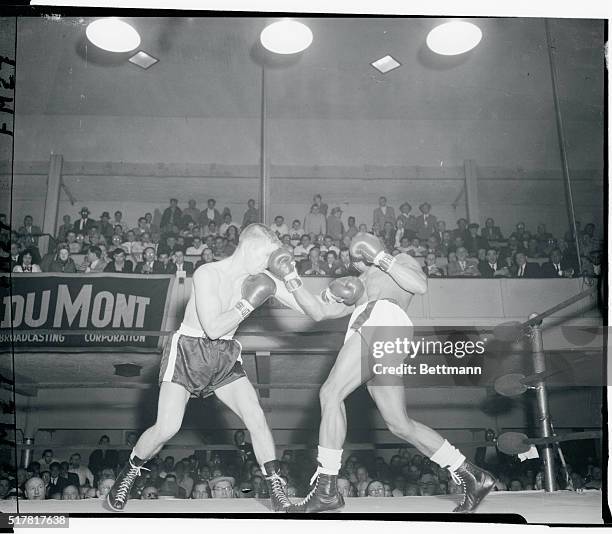 Bobby Courchesne, of Holyoke, Massachusetts, takes a solid left on the nose which was thrown by Miguel Berrios of Puerto Rico during the fourth-round...