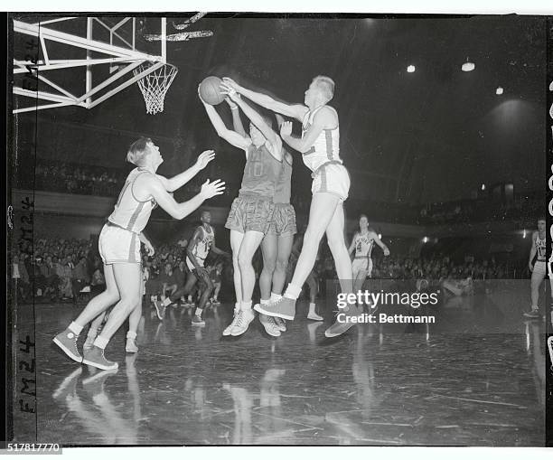 Jack Twyman , of Rochester, grabs a rebound from under the outstretched arm of Ken Sears of the Knickerbockers during the fourth quarter of tonight's...