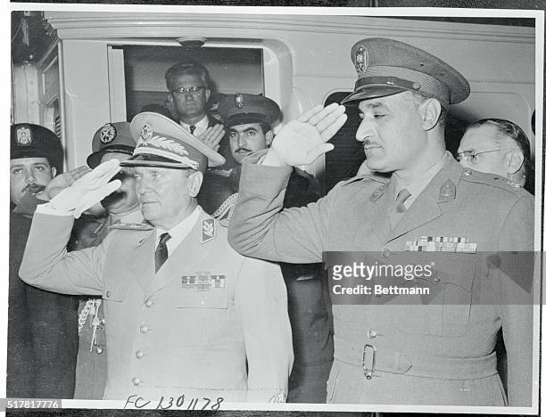 Marshal Tito, President of communist Yugoslavia, is shown with Egyptian premier Gamal Andel Nasser as they took the salute from the guard of honor on...