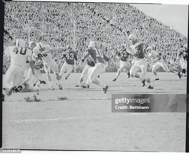Oklahoma's left halfback Tom McDonald breaks through Maryland's line for a seven yard gain in the first quarter of today's Orange Bowl Game in Miami....