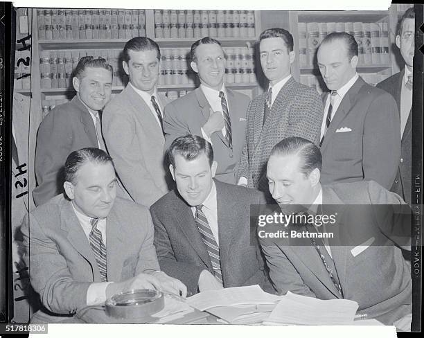 Norman Lewis, , seated, the attorney for baseball players in their dealings with major league owners is shown with a group of players representatives...