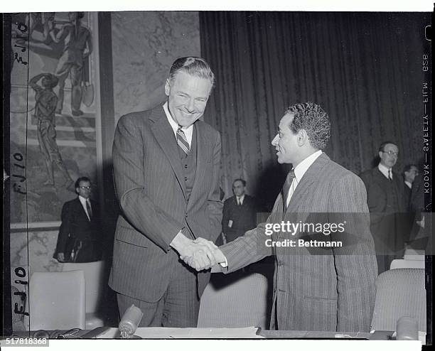 Henry Cabot Lodge, Jr., United States Ambassador to the United Nations, shakes hands with Sayed Hosni, representative of the Sudanese Colony, shortly...