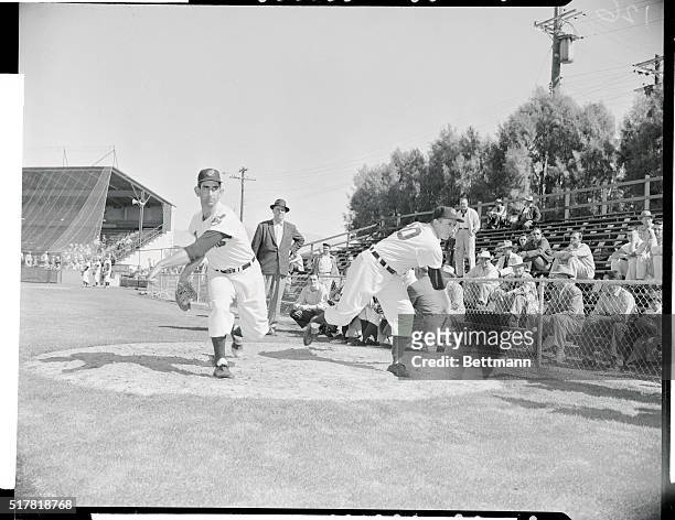 Don Mossi and Ray Narleski, a pair of the old reliables of the Cleveland Indians pitching staff, warm up together at a spring practice session in the...