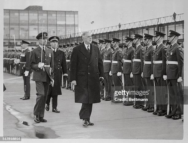 French President Charles de Gaulle inspects honor guard at Gatwick Airport here Nov. 24th following his arrival for confidential weekend talks with...