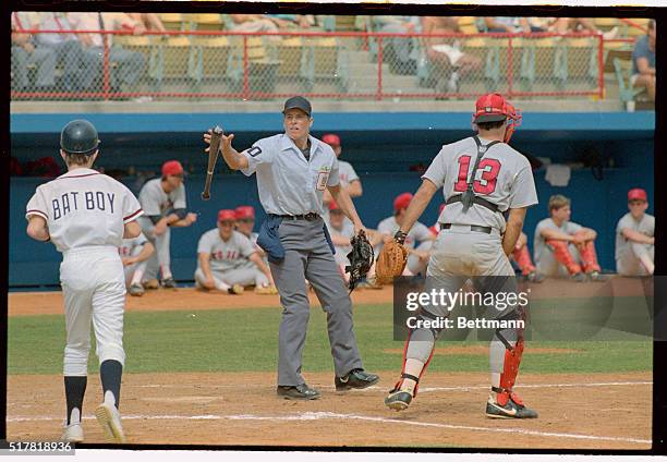 National League Umpire Pam Postema tosses a bat to the Atlanta Braves bat boy during her 1st major league game between the Braves and the University...