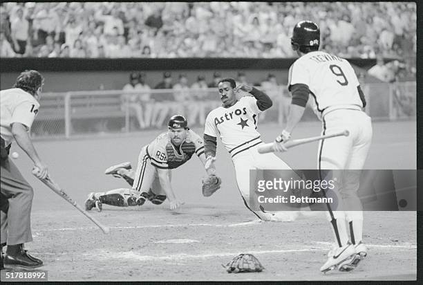 Houston: Houston Astros' Kevin Bass slides home to score past tag by Pittsburgh Pirates' catcher Mike Lavalliere in 3rd inning of the Astros Pirates...