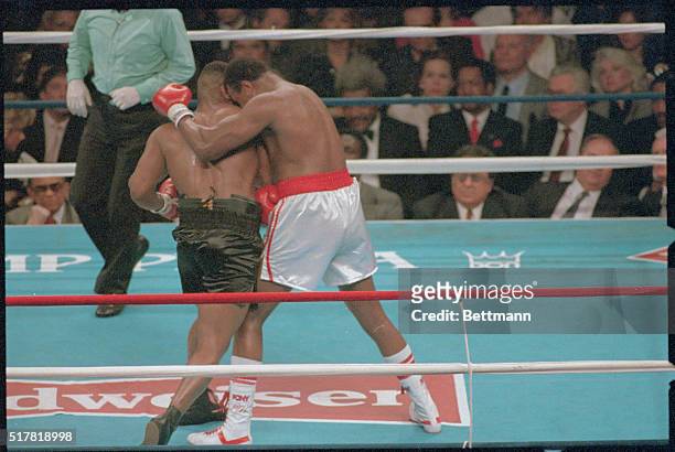 Atlantic City, N.J.: World Heavyweight Champion Mike Tyson watches challenger Larry Holmes fade into the ropes during 4th round knockout.