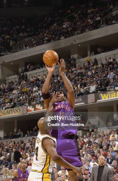 Forward Jerome Williams of the Toronto Raptors shoots over point guard Travis Best of the Indiana Pacers during the NBA game at Conseco Fieldhouse in...