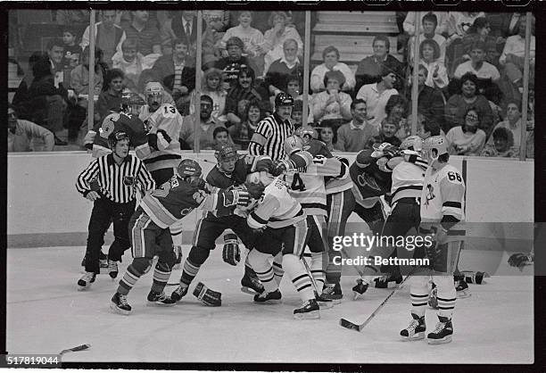 Penguin's Mario Lemieux looks on at right as his teammates and Blues players get into brawl in the first period of game here. The brawl was triggered...