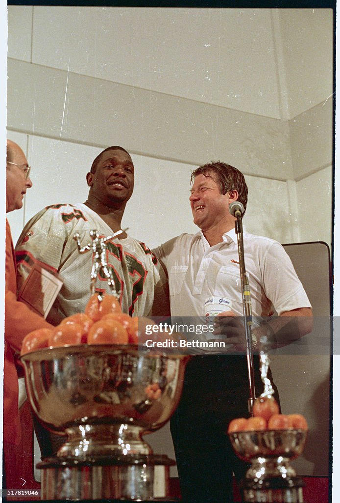Jimmy Johnson and Bernard Clark Posing with Trophy