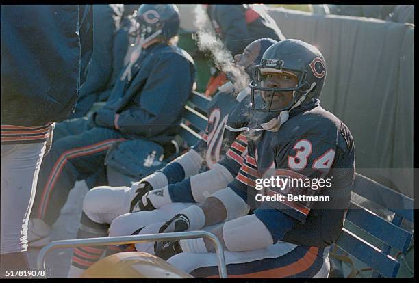 Bears' Walter Payton, all-time NFL rushing champion, sits on sideline near the end of the game as his team is behind, 21-17 at Soldier Field. His...