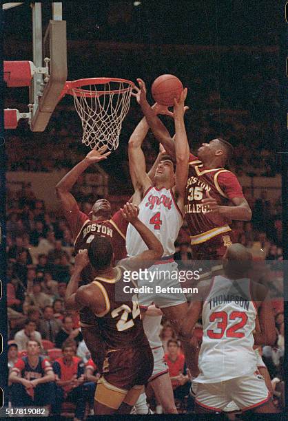 Big East quarterfinal at Madison Square Garden 3/11 saw Syracuse defeat Boston College, 67-53. Battle under the boards shows Syracuse's Rony Seikaly...
