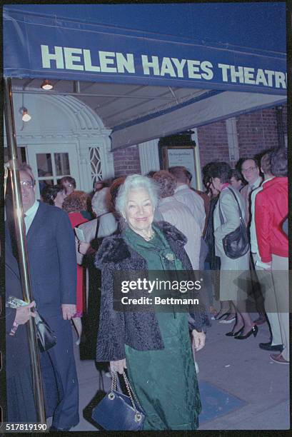 New York: Helen Hayes sands smiling outside her namesake theater.