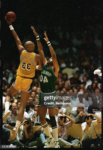 Laker center Kareem Abdul-Jabbar goes up over Dallas center James Donaldson to put in a "skyhook" for 2 points in the 2nd quarter.