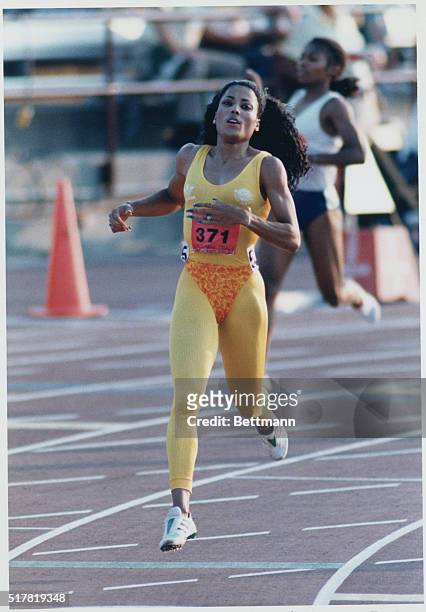 Olympic Track and Field Trials. Indianapolis, Indiana: Florence Griffith-Joyner coasts along, July 22, after setting a new US record in the 200-meter...