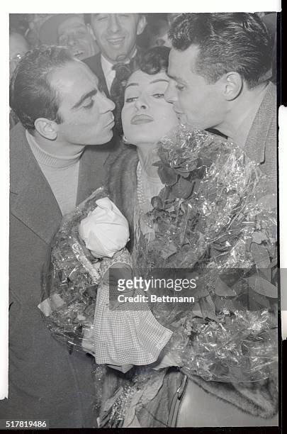 Kisses on the cheeks of Italian film star Silvana Pampanini form a pledge of victory by Italian soccer aces, A. Pesaola and F. Giuliano, members of...