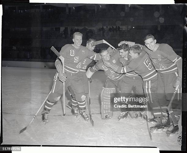 High-spirited U.S. Hockey team mobs goalie Willard Ikola after dealing Canada's Olympic champions a stunning 4-1 upset in the final round robin of...
