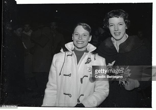 American figure skating champs Tenley Albright , of Newton, MA, and Carol Heiss, of Ozone Park, NY, smile as they leave the ice stadium at Cortina,...
