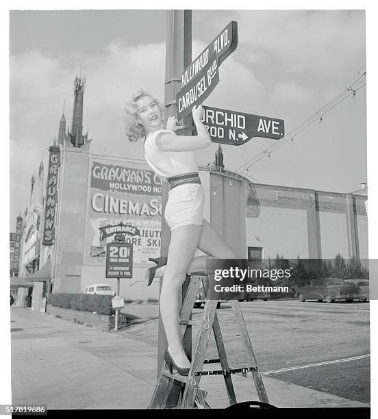 Shapely actress Kathy Marlowe, who appears in Carousel, the first motion picture to be released in the new Cinemascope 55mm process, does her bit to...