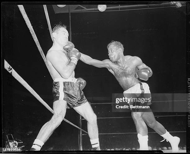 Cuba's sensation Isaac Logart connects with a long right which jars the mouthpiece of Ramon Fuentes in the ninth round of their welterweight bout at...