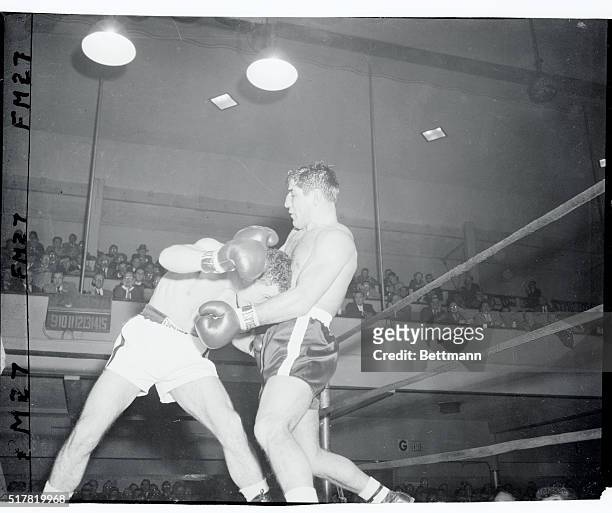 Peter Muller , German middleweight, gets a chest full as Ray Drake moves in head first in the second round of their bout at ST. Nick's Arena tonight....