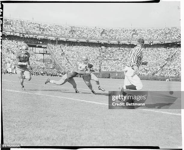 Georgia Tech's Volkert gallops around end to pick up five yards before being knocked out of bounds by Pittsburgh's Paluck , who approaches the play...