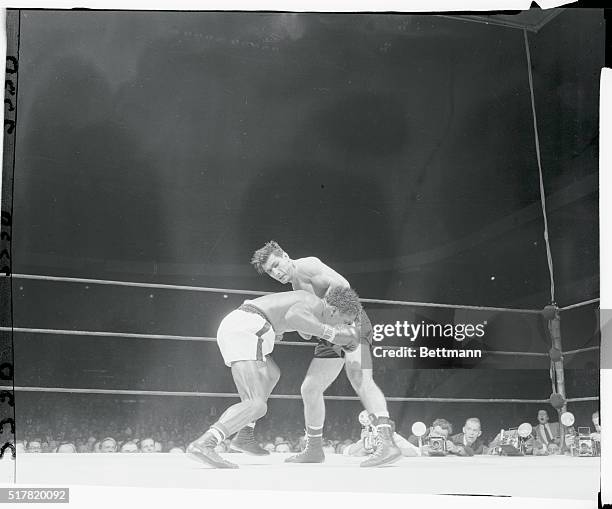 Eduardo Lausse stuns Milo Savage with a left hook in the tenth round of their middleweight go at the Garden tonight. Savage of Salt Lake City fought...