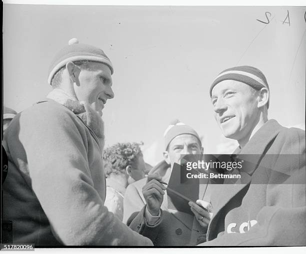 Sixten Jernberg of Sweden, is shown as he congratulated Vladimir Kuzin on the Soviet victory in the 40 kilometer cross country relay event in the...