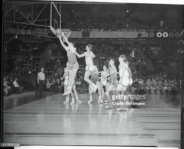 Tom Heinsohn of Holy Cross grabs a rebound in the first half of the consolation game in the holiday festival at the Garden tonight. Duquesne's Jack...