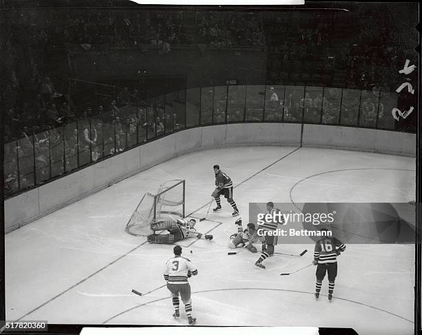 New York Ranger's goalie Lorne Worsley lies prone here, after going all out to make a save in the second period of game against the Chicago Black...