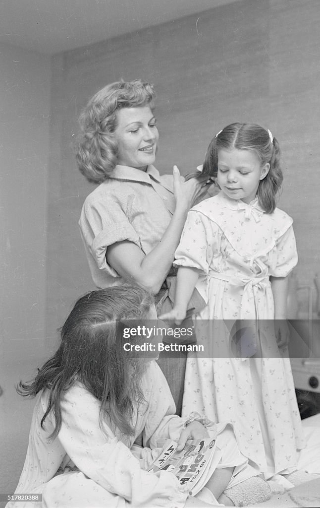 Rita Hayworth Combing Daughter's Hair