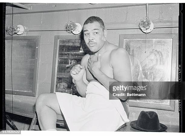 Joe Louis is shown is his dressing room after his first venture as a pro wrestler proved successful. Louis defeated Don "Cowboy Rocky" Lee in 11...