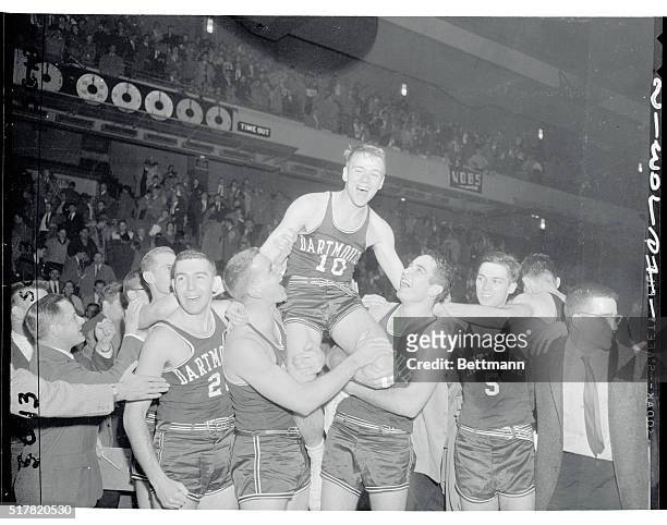 Sharp-shooter Larry Blades of Dartmouth is carried off the court by teammates after sinking a field goal with one second remaining in the game to...