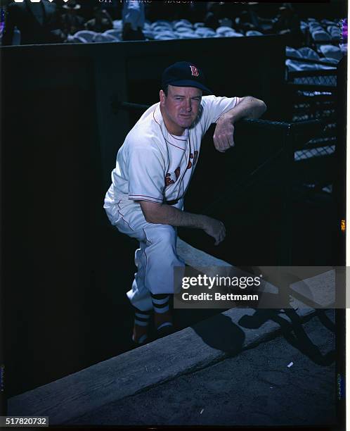 Boston Red Sox Manager Joe Cronin is shown standing at the edge of the dugout in a baseball stadium.