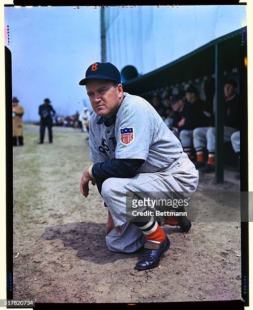 Boston Red Sox Manager Joe Cronin is shown kneeling during what appears to be a game.