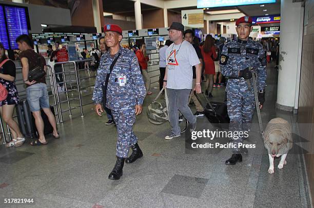 Thai K9 unit patrols and dog soldiers from Royal Thai Air Force Security Forces command to explore and search for explosives at Don Mueang...