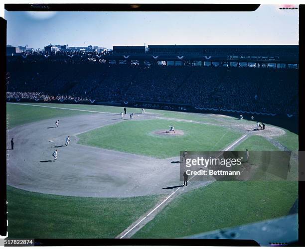 Photo shows baseball action in Boston's Fenway Park. The pitcher is in the process of throwing the ball.