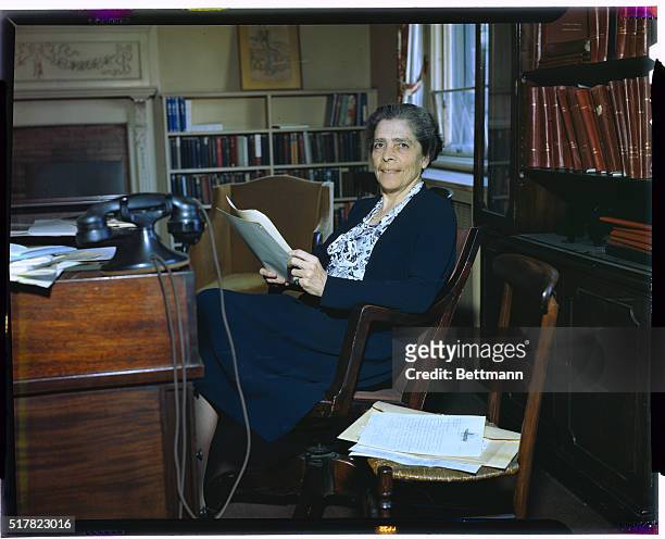 Photo shows Virginia Gildersleeve, Dean of Barnard College seated at a desk.