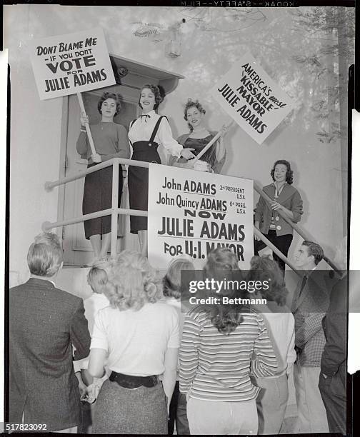 Actress Julie Adams is supported by a couple of placard carrying beauties as she gets into the campaign for the post of Mayor of Universal City in...