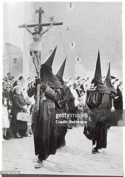 Carrying the crucified Christ, these somber "Black Penitents" hold their annul procession through the streets of Perpignan, France, on Holy Thursday....