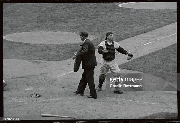 Yankee catcher Yogi Berra blocks the plate and waits with ball in hand to tag out sliding Frank Sullivan of Boston during the sixth inning of the...