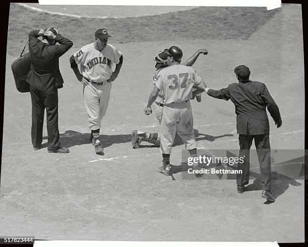 Umpire Charley Berry reaches for Jim Piersall's arm after Indians outfielder was ejected from game in 1st inning of Cleveland Indians-Washington...