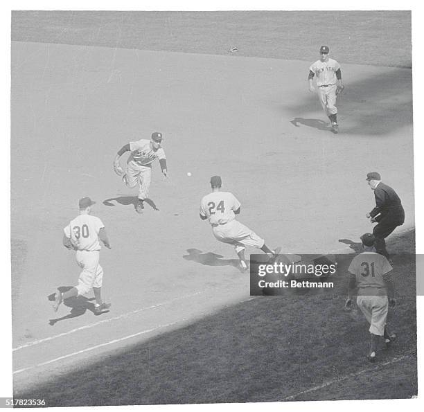 New York, NY: Yankee second baseman Joe Collins tossing the ball to pitcher Tom Gorman, covering first base on the play, as Dodger pitcher Billy Loes...